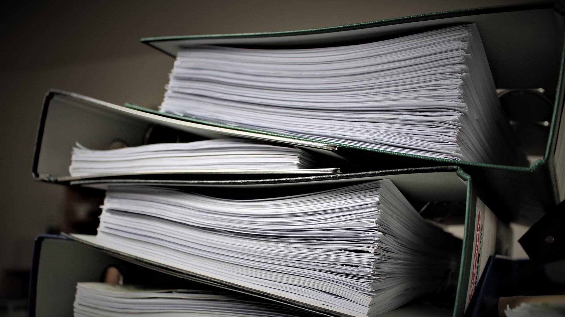 stacks of binders and paperwork