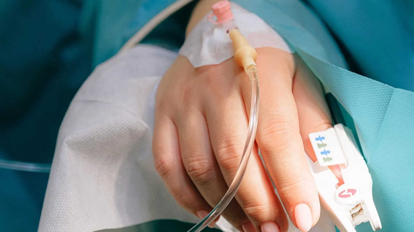 a patient's hand with IV drip