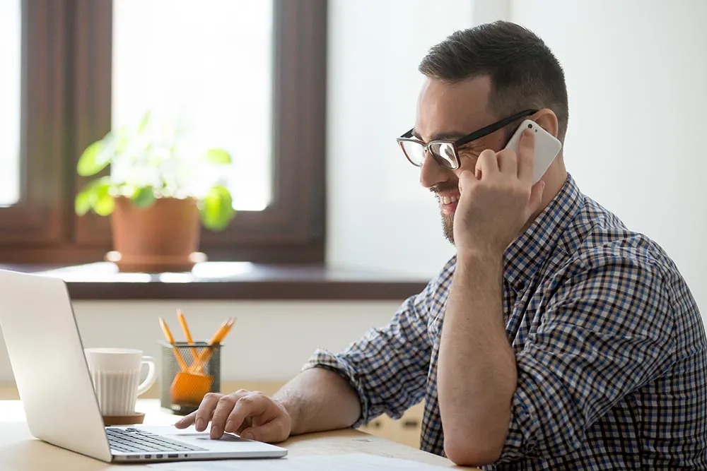 client smiling while talking on the phone