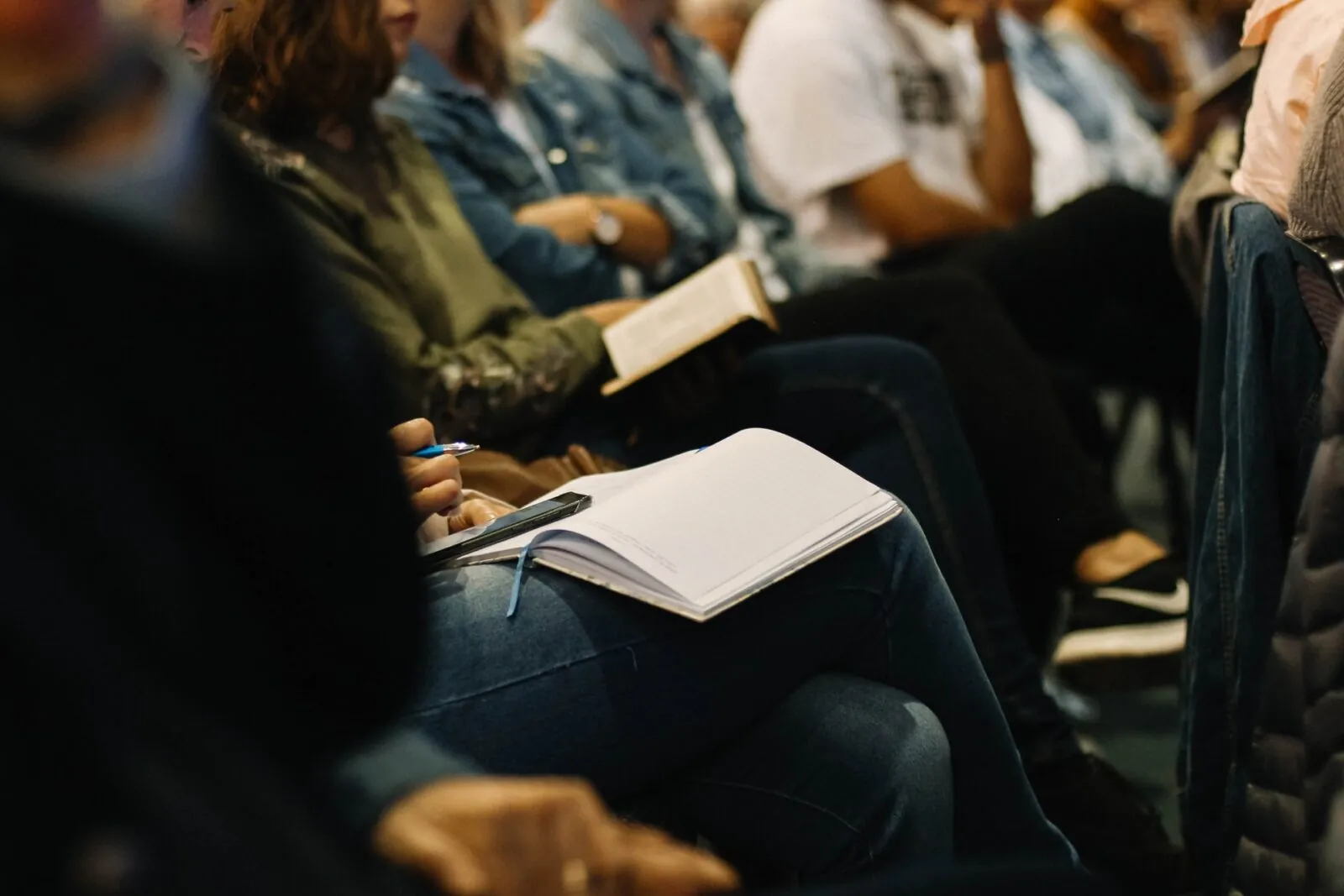 crowd of students sitting in desks with open books